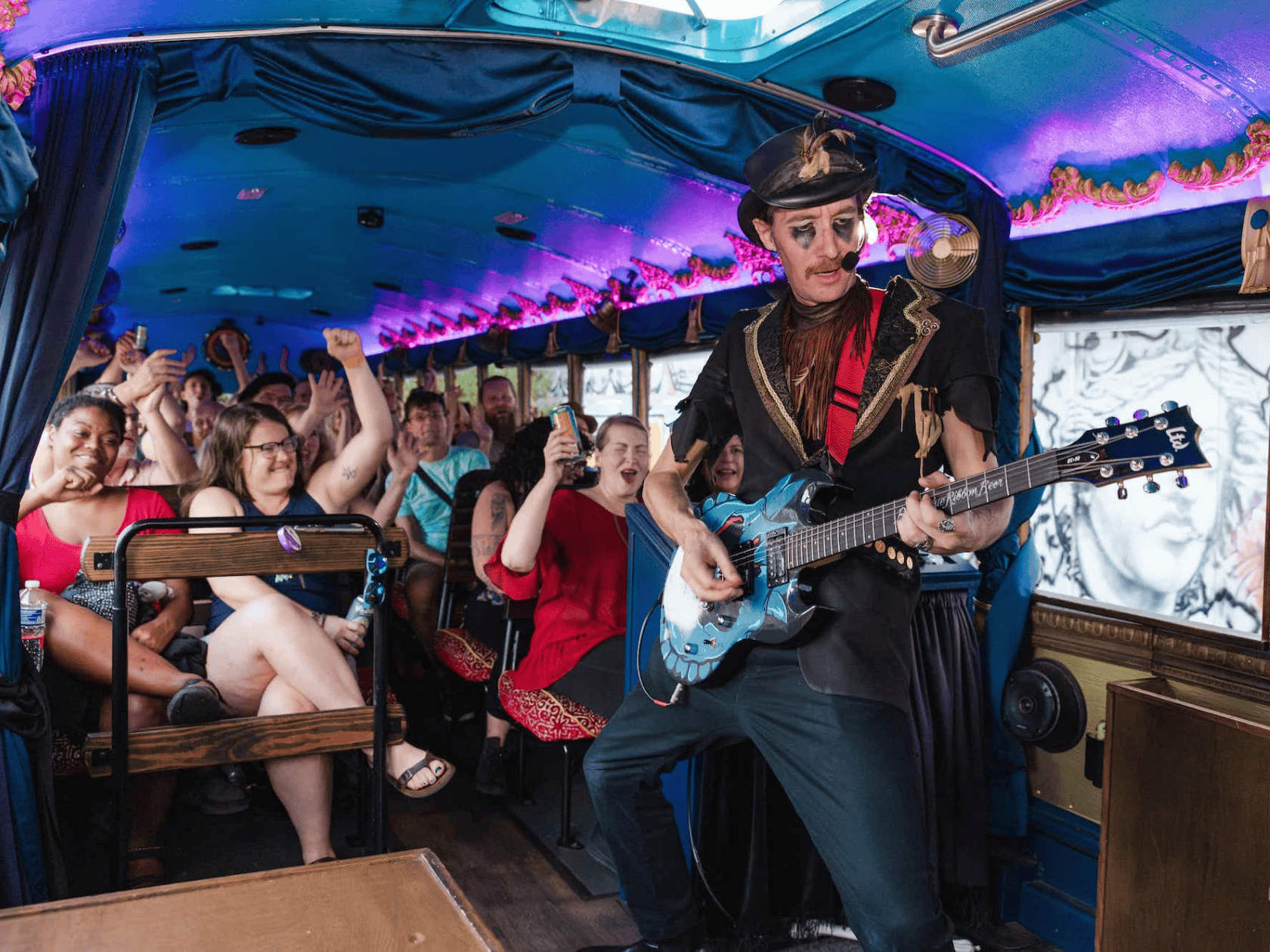 A conductor in halloween costume giving a live tour of the town